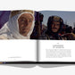 An open book by Assouline, titled "Columbia Pictures," displays a photo of two individuals in desert attire and text highlighting the film "Lawrence of Arabia," emphasizing its significance in 100 Years of Cinema.
