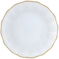 A white, round porcelain plate from the Corail Gold Collection by Medard de Noblat/Devine features a scalloped edge and thin gold rim, photographed from above against a white background.