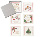 The Kim Seybert Merry and Bright Cocktail Napkin Set features six embroidered holiday napkins with festive designs, beautifully packaged in a gray branded box—perfect as a hostess gift or to elevate your holiday table linens.