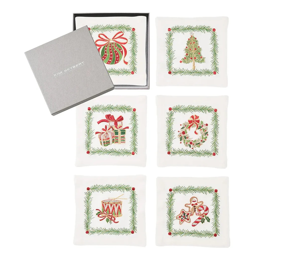 Set of five Christmas Trellis Cocktail Napkins featuring embroidered Christmas motifs in evergreen frames, displayed with their gift box.
