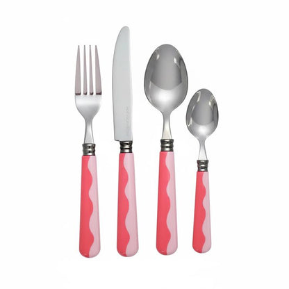 A fork, knife, tablespoon, and teaspoon with pink and white wavy handles from the Addison Ross Wave Flatware Collection are arranged side by side on a white background.