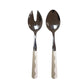 The Addison Ross Wave Salad Server Set features a serving spoon and slotted fork with stainless steel heads and white wavy handles, adding elegance to any table setting.