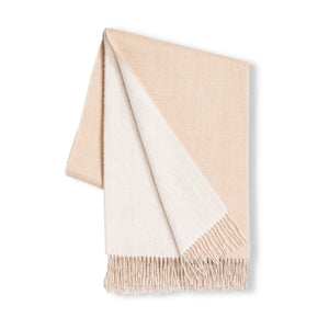 The Alicia Adams Alpaca Reversible Throw, in beige and cream with fringed edges, offers refined softness and is shown against a white background.