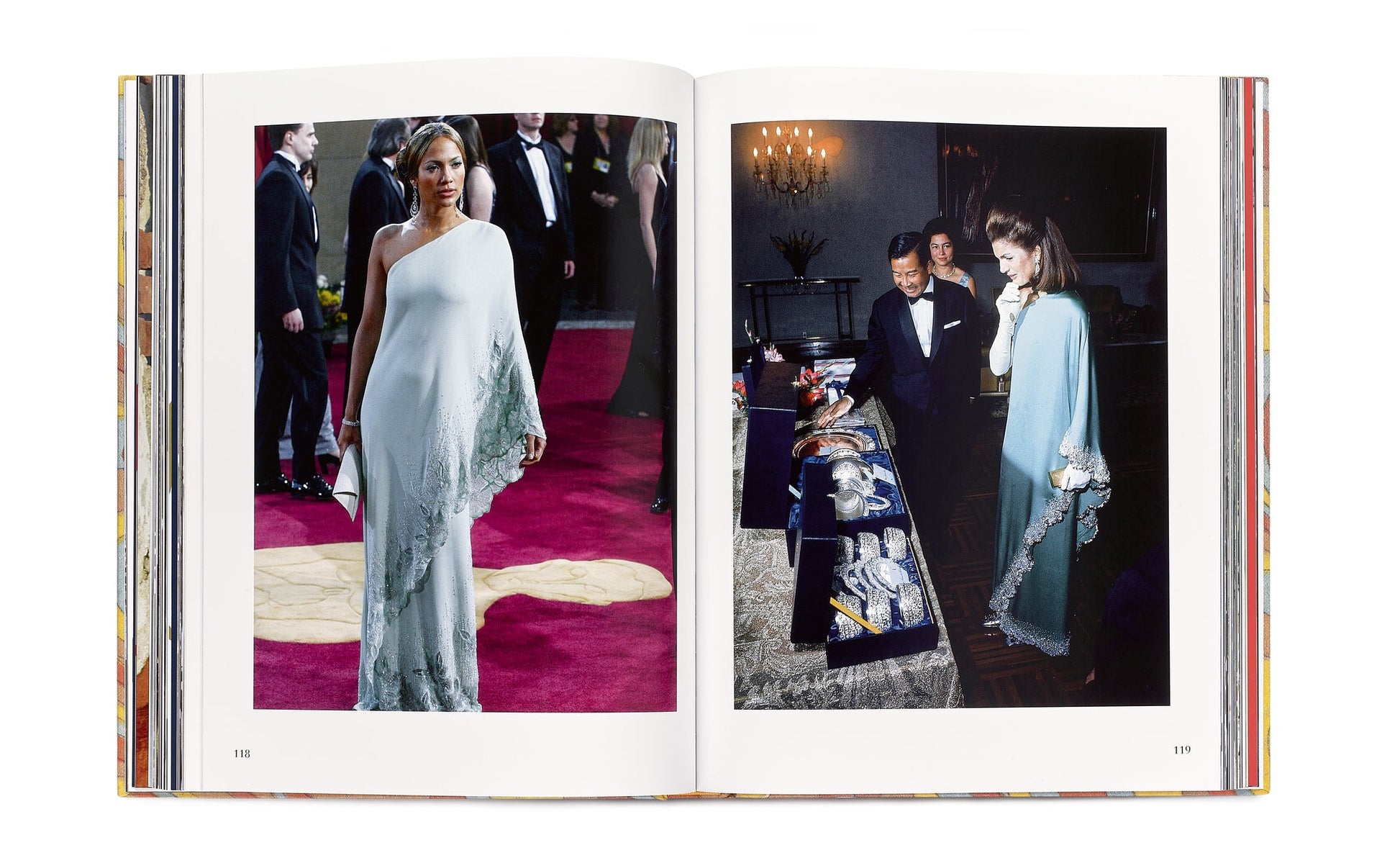 An open book, "Caftans: From Classical to Camp" by Vendome, reveals images of a person in a stunning caftan couture on a red carpet and two people admiring resort-themed jewelry.