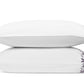 Two white pillows from the Matouk Callista Bedding Collection are stacked atop one another, each crafted from luxurious Giza Egyptian cotton and featuring an elegant purple floral pattern along the right edge.