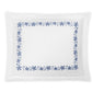 The Callista Bedding Collection by Matouk showcases a white pillowcase made from premium Giza Egyptian cotton, adorned with a rectangular blue floral border and decorative embroidery along the edges, elegantly presented against a plain white background.