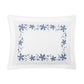 The Callista Bedding Collection pillowcase by Matouk showcases a white rectangular design adorned with decorative blue floral vine embroidery along the edges, set against a plain white background.