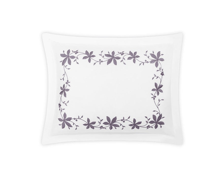 The Callista Bedding Collection Lilac pillowcase by Matouk is crafted from luxurious Giza Egyptian cotton, featuring a lilac floral embroidered border on a crisp white background.