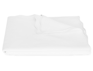 The Camilla Pique Coverlet by Matouk, crafted from pure cotton with smooth, slightly wavy edges, is neatly folded and displayed on a plain white background.