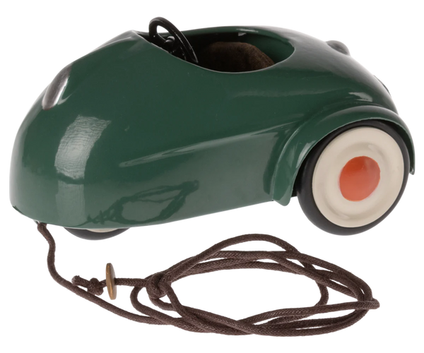 The Maileg Mouse Car - Dark Green by Maileg is a charming vintage pull toy car with a brown string attached, white wheels featuring orange centers, and it's perfect for transporting mice.