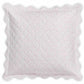 The Matouk Celine Bedding Collection, Pink, features a square decorative pillow with scalloped edges crafted from Egyptian cotton percale and adorned with small pink and red dots on a white background.