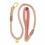 The Found My Animal Waxed Cotton Canvas Leash Collection features a handcrafted beige rope dog leash with a pink padded handle, gold metal clasp, and a round gold tag.