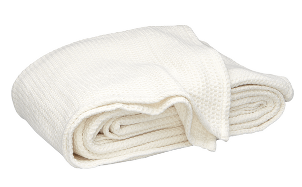 A folded Matouk Chatham Blanket in ivory, crafted in Portugal, is displayed against a plain white background.