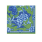 The Caspari Chinoiserie Collection napkin is a green, triple-ply option with blue floral and bird designs, featuring peonies and borders—an elegant, eco-friendly choice for any occasion.
