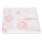 A folded white bed sheet from the Tillett Chrysanthemum Bedding Collection by Matouk, featuring a light pink chrysanthemum floral pattern and crafted from luxurious Luca percale, displayed on a white background.