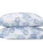 Two white pillows from the Matouk Tillett x Matouk Chrysanthemum Bedding Collection in Blue, featuring blue floral motifs, are stacked against a plain white background.