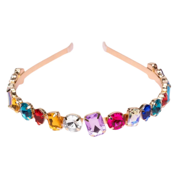 The Great Pretenders Chunky Gem Headband is a gold headband embellished with gemstones in clear, purple, red, orange, blue, and green hues. This trendy bold statement piece is ideal for adding a pop of color to any outfit and makes a fantastic accessory for a child's ensemble.