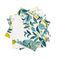 A stack of folded cloth napkins from Matouk's Citrus Garden Pool Collection, featuring a blue, green, and yellow botanical print with leaves and fruits on white—perfect to pair with a linen tablecloth.
