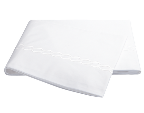 White bedsheets from the Matouk Classic Chain Bedding Collection feature an embroidered pattern along the edge, crafted from a crisp-feel cotton percale with a 350 thread count. These luxurious sheets by Matouk are OEKO-TEX Standard 100 certified for extra peace of mind.