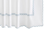 The Classic Chain Scallop Shower Curtain Collection by Matouk features white fabric accented with scalloped edges and delicate light blue chain embroidery in a twisted rope pattern along the border, evoking a subtle Greek motif—an elegant addition to your bathroom décor.