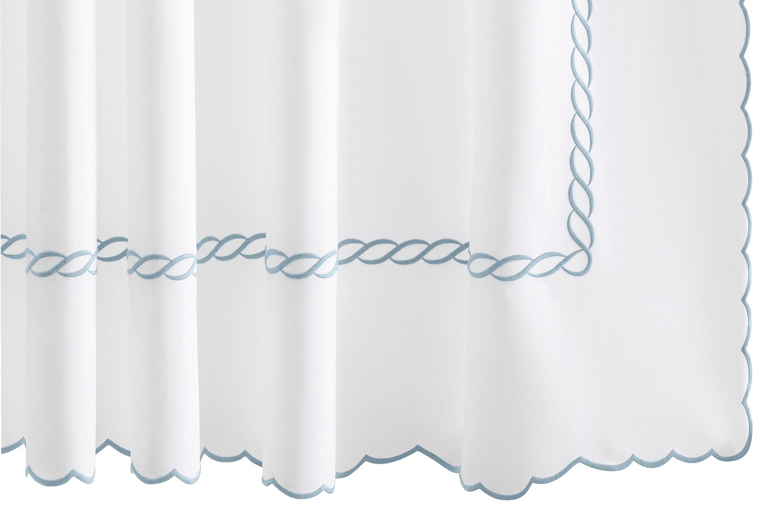 The Classic Chain Scallop Shower Curtain Collection by Matouk features white fabric accented with scalloped edges and delicate light blue chain embroidery in a twisted rope pattern along the border, evoking a subtle Greek motif—an elegant addition to your bathroom décor.