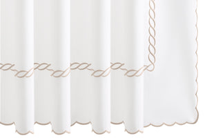 Experience timeless elegance with the Matouk Classic Chain Scallop Shower Curtain Collection, featuring a white curtain adorned with beige chain embroidery in a wavy line pattern near the scalloped hem—perfect for elevating any bathroom décor.