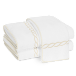 Two folded Matouk Classic Chain Bath Collection towels in Cairo cotton terry, featuring beige chain embroidery and matching trim, displayed on a white background.