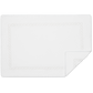 A white rectangular bath mat from Matouk's Classic Chain Bath Collection, made of plush Cairo cotton terry with a subtle chain border and one corner neatly folded over.