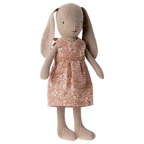 The Maileg Bunny Size 1, Classic - Flower Dress, is a beige stuffed toy bunny crafted from soft natural fabrics and dressed in a charming pink floral dress.