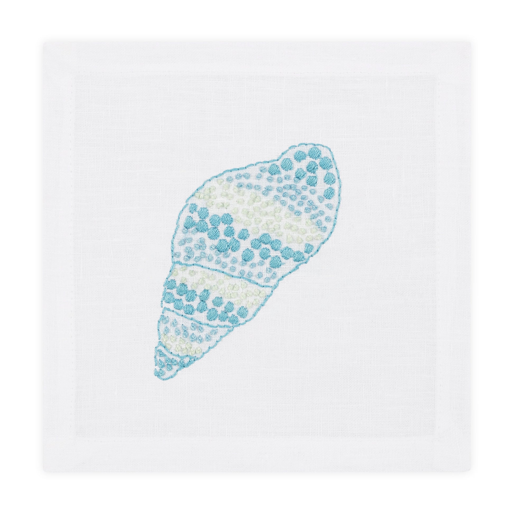 The Speckled Conch Coaster Set by Haute Home is a white linen coaster set with a hand embroidered blue and green seashell design in the center.