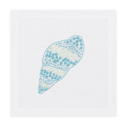 The Speckled Conch Coaster Set by Haute Home is a white linen coaster set with a hand embroidered blue and green seashell design in the center.