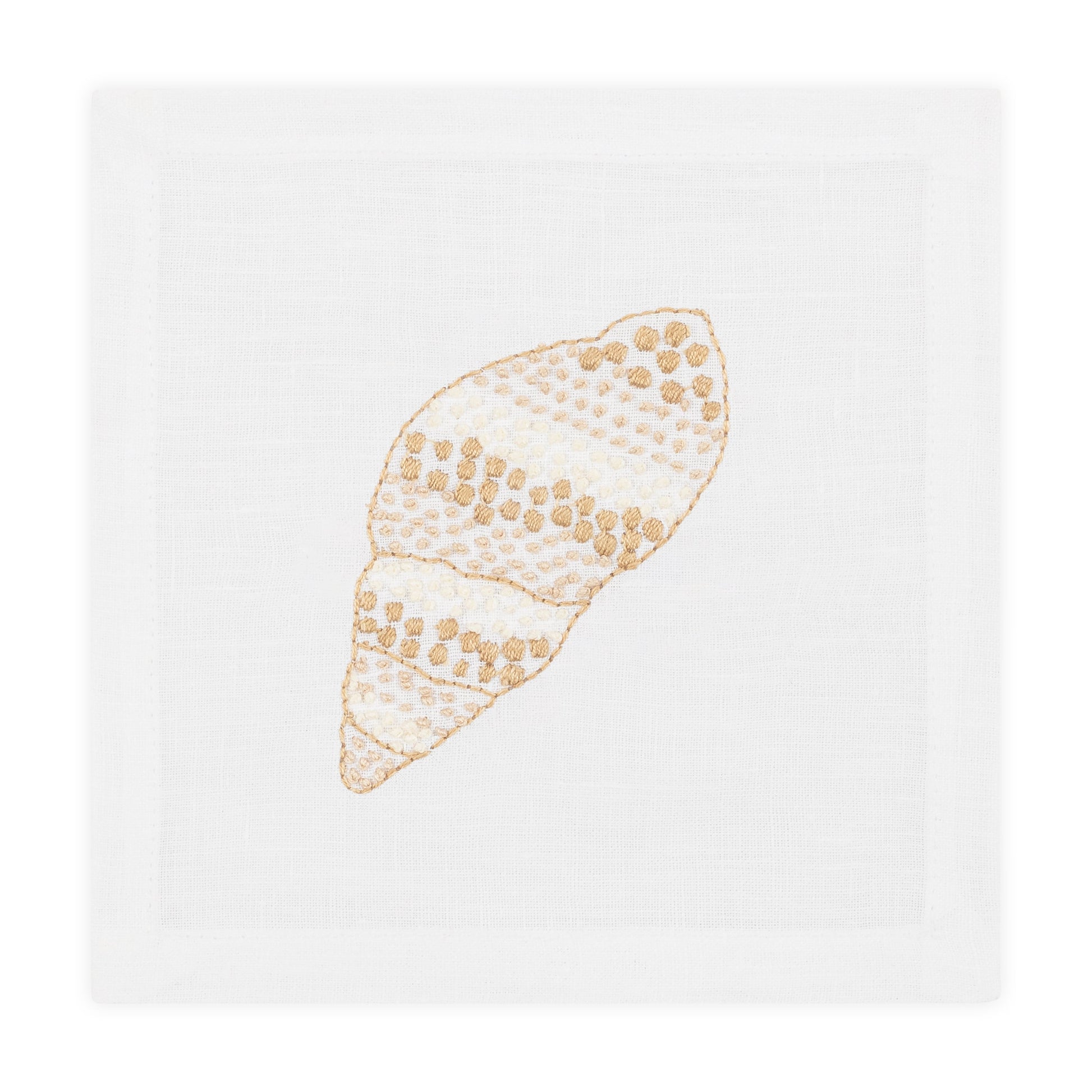 The Haute Home Speckled Conch Coaster Set features white cloth napkins with embroidered beige and gold seashells, perfectly complementing the elegant coasters for a refined table setting.