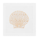 The Speckled Shell Coaster Set by Haute Home features a white Italian linen design with a hand-embroidered tan seashell motif at the center.