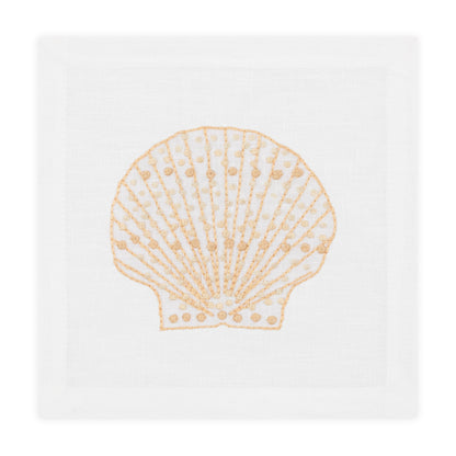 The Speckled Shell Coaster Set by Haute Home features a white Italian linen design with a hand-embroidered tan seashell motif at the center.