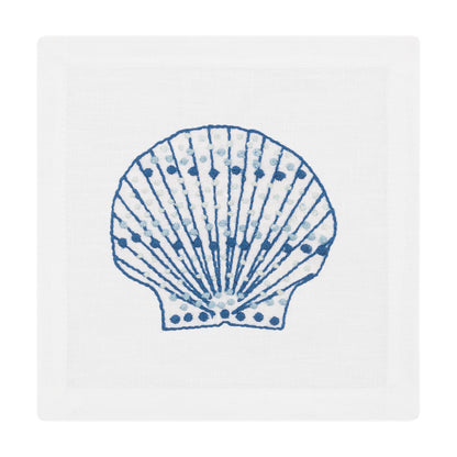The Speckled Shell Coaster Set by Haute Home features blue and white scallop shell illustrations centered on fine Italian linen coasters.