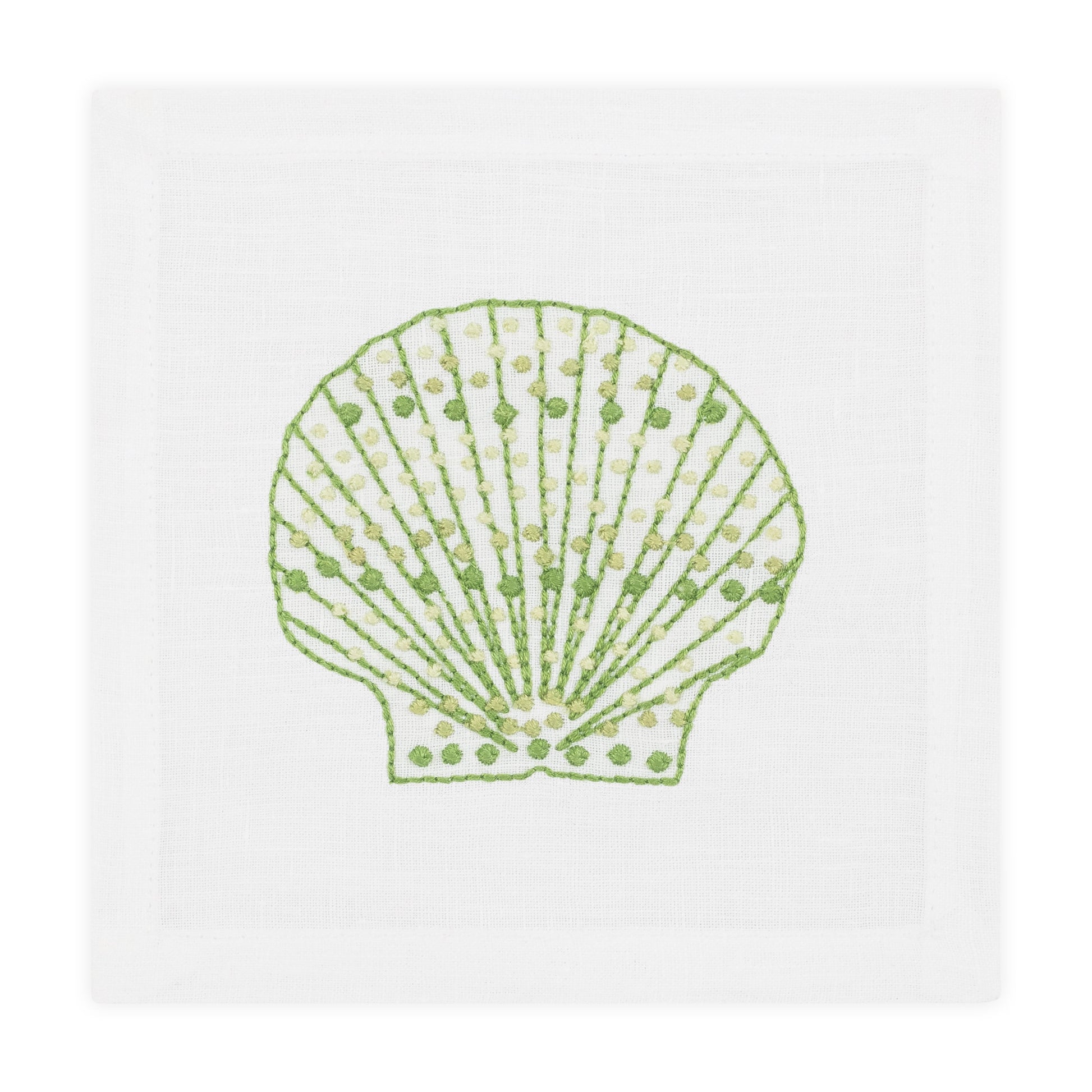 The Speckled Shell Coaster Set by Haute Home features coasters with a green and yellow hand-embroidered seashell design on white Italian linen.
