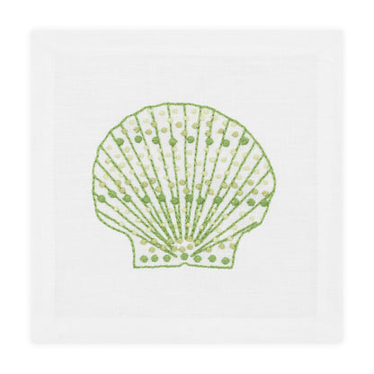 The Speckled Shell Coaster Set by Haute Home features coasters with a green and yellow hand-embroidered seashell design on white Italian linen.