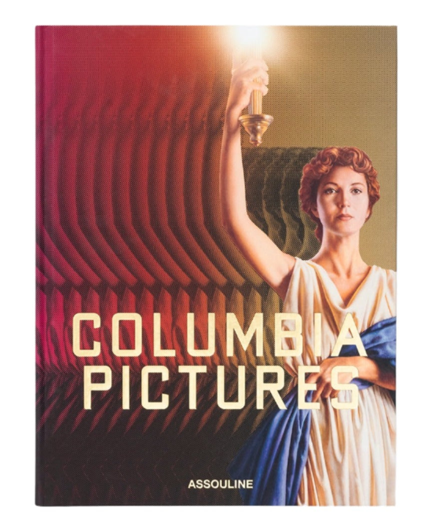 A book cover titled "Columbia Pictures" by Assouline celebrates 100 Years of Cinema, featuring a woman holding a torch against a textured background with the names "Columbia Pictures" and "Assouline" at the bottom, evoking a rich film history.