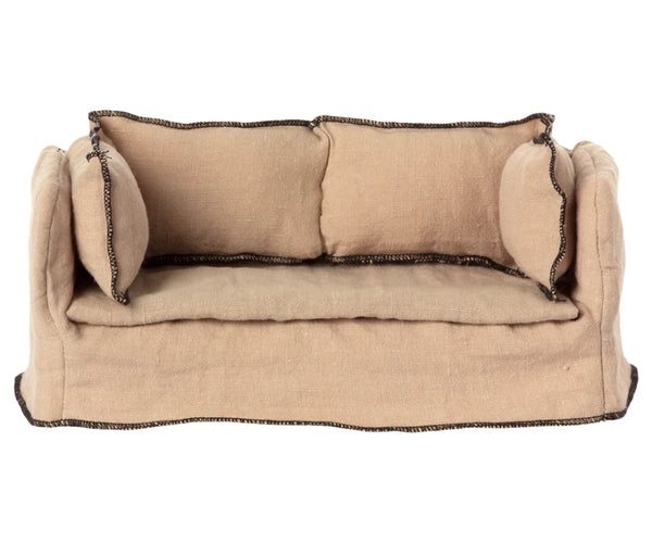 The Maileg Couch, Miniature, is a small tan fabric sofa featuring two matching cushions and dark trim along the edges—an ideal addition to complement your Maileg dollhouse.