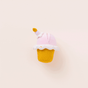 The Foggy Dog Cupcake 2-in-1 Bounce Dog Toy features a plush cupcake shape with pink frosting, white icing, colorful sprinkles, and a candle on top, displayed against a light background.