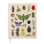 A cream notebook cover from the Riffle Paper Co. Curio Desk Accessory Collection, adorned with illustrated bugs and plants—moths, butterflies, beetles, flowers, and leaves—a perfect gift for garden enthusiasts.