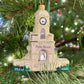 The Palm Beach Clock Tower Custom Ornament by Joy To The World Collectibles, Inc. hangs on a Christmas tree decorated with green needles and lights.