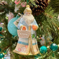 The Hive Santa Custom Ornament by Joy To The World Collectibles, Inc. features a sun-soaked Santa in blue and white with beachy details, holding a "HIVE" bag, hanging on a festive tree with pinecones and teal ornaments.