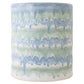 The Cylindrical Garden Stool Collection by Paul Schneider Ceramics features ceramic stools with blue and green drip glaze over white. Each piece is unique, making it a perfect addition to any decor.