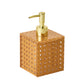 The Kim Seybert Natural Reed Bath Collection soap dispenser, with its square shape, woven rattan design, and gold pump, enhances your home decor with style.