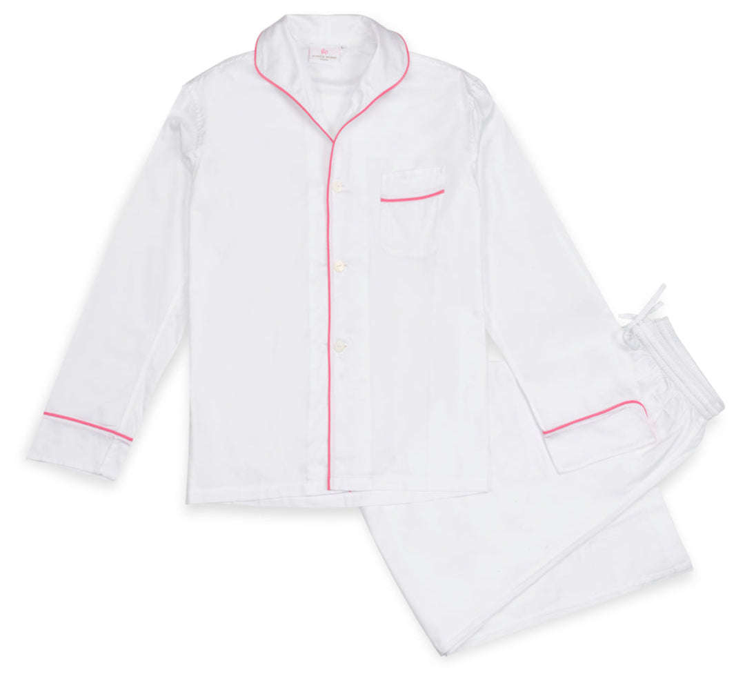 Experience luxury sleep in the Haute Home Smart Pajama Pant Set, made from white cotton sateen with pink piping. The set includes a button-up shirt with a chest pocket and drawstring pants, shown laid flat on a white background.