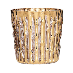 The Kim Seybert Gold Bamboo Tumbler is crafted from mouth-blown glassware with a textured, vertical bamboo-inspired pattern, finished with hand-applied 24k gold for an elegant touch.