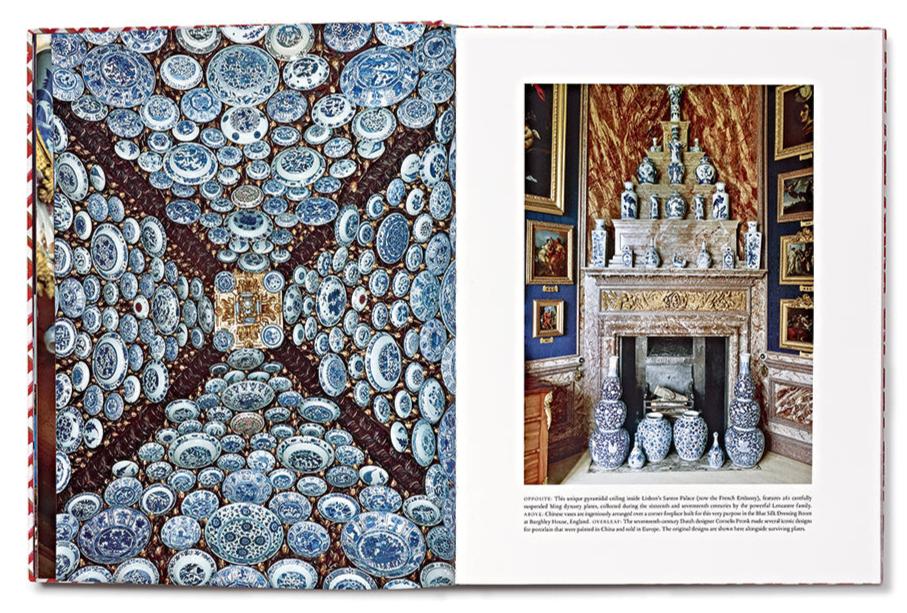 An open book displays a page highlighting blue and white Chinoiserie porcelain plates on a ceiling, while the adjacent page presents a fireplace embellished with similar vases, reflecting the elegance of Vendome's "Dragons & Pagodas: A Celebration of Chinoiserie.