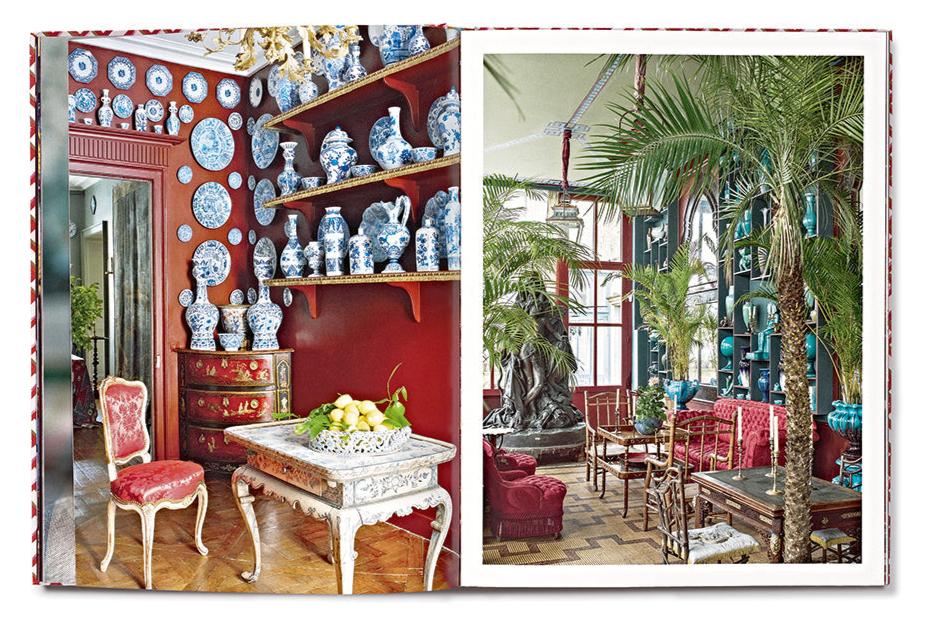 A book open to pages reveals an opulent interior filled with ornate furniture, red walls, and decorative blue and white porcelain items, exuding a Chinoiserie charm reminiscent of the elegance captured in Vendome's "Dragons & Pagodas: A Celebration of Chinoiserie.