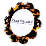 The Daisy Frame by Tara Wilson Designs is a flower-shaped acrylic frame with a tortoiseshell pattern—an ideal whimsical accent for your photo collection.